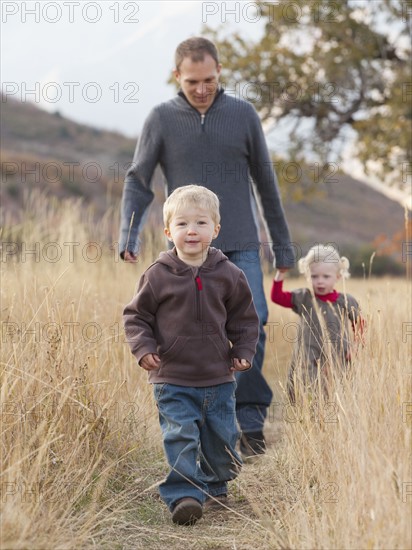 Family walking in a meadow. Photographer: Mike Kemp