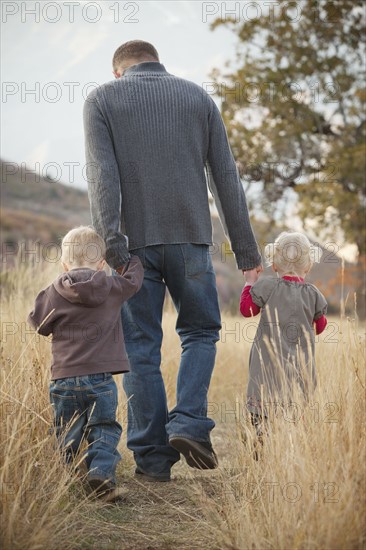 Family walking in a meadow. Photographer: Mike Kemp