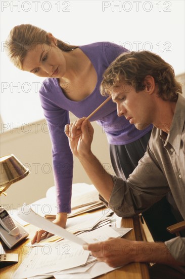 Couple looking at bills. Photographer: Rob Lewine