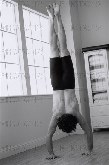 Man doing yoga. Photographer: Rob Lewine