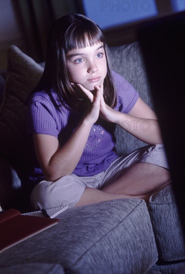 Girl watching television. Photographer: Rob Lewine