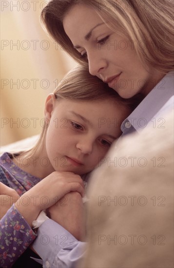 Mother consoling daughter. Photographer: Rob Lewine