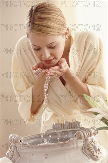 Women washing her face. Photographer: Rob Lewine