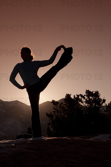 Woman doing yoga outdoors. Photographer: Dan Bannister