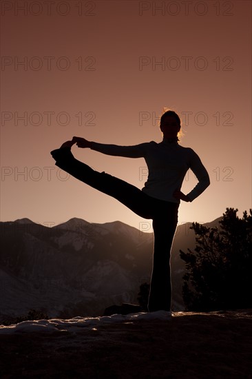 Woman doing yoga outdoors. Photographer: Dan Bannister