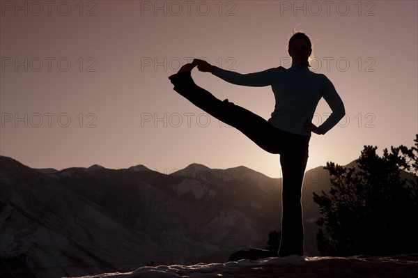 Woman doing yoga outdoors. Photographer: Dan Bannister