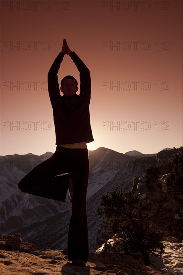 Man doing yoga outdoors. Photographer: Dan Bannister