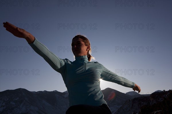 Woman doing yoga outdoors. Photographer: Dan Bannister