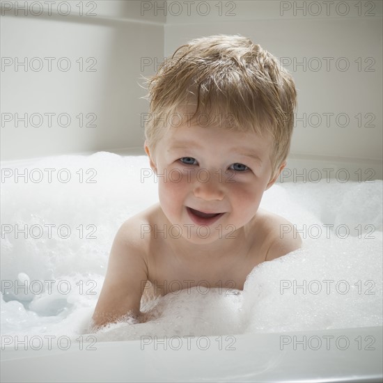 Boy in bubble bath. Photographer: Mike Kemp