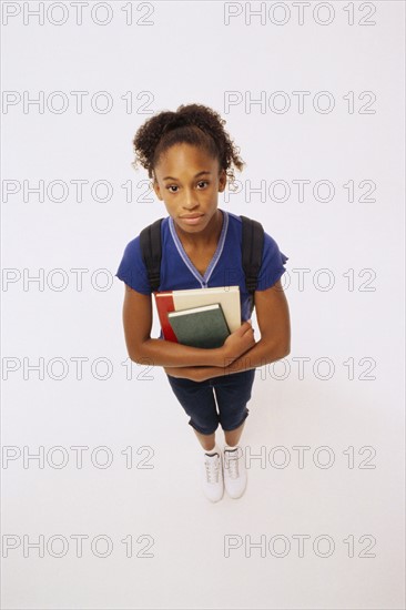 Student holding books. Photographer: Rob Lewine