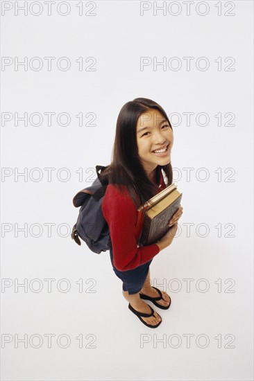 Student holding books. Photographer: Rob Lewine