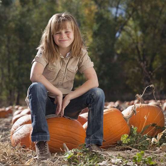 Girl in pumpkin patch. Photographer: Mike Kemp
