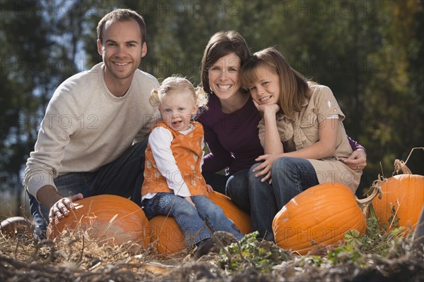 Family in pumpkin patch. Photographer: Mike Kemp