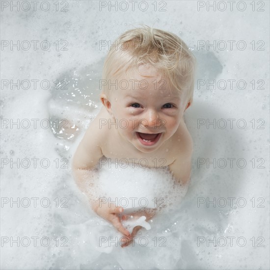 Baby having a bubble bath. Photographer: Mike Kemp