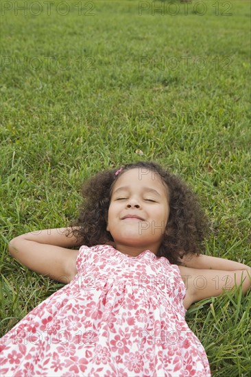 Girl lying on grass. Photographer: Pauline St.Denis