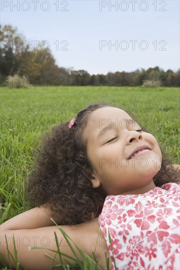 Girl lying on grass. Photographer: Pauline St.Denis