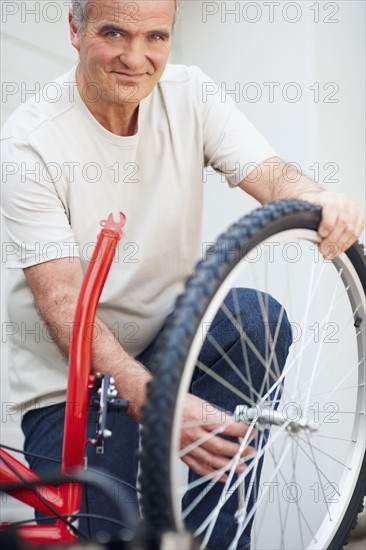 Man repairing bicycle. Photographer: momentimages