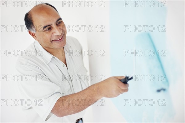 Man painting wall. Photographer: momentimages