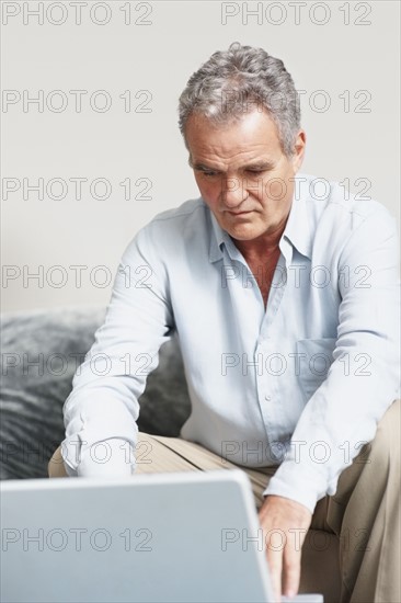 Man working on laptop. Photographer: momentimages