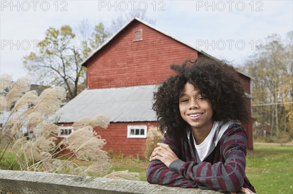 Child leaning on fence. Photographer: Pauline St.Denis