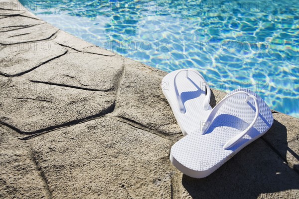 Flip flops by the pool. Photographer: Chris Hackett