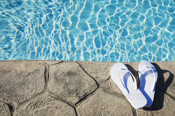 Flip flops by the pool. Photographer: Chris Hackett