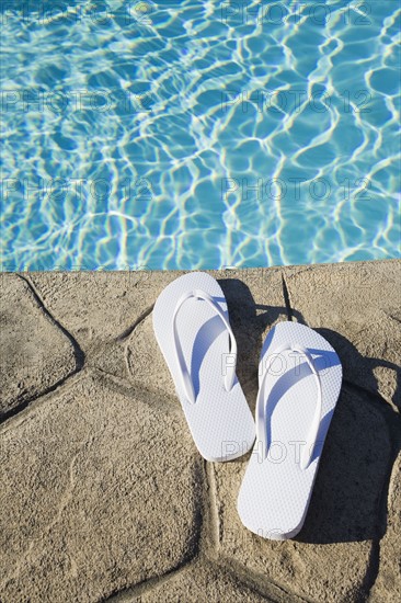 Flip flops by the pool. Photographer: Chris Hackett