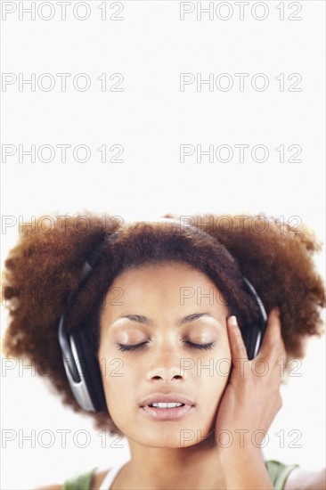 Woman listening to music. Photographer: momentimages