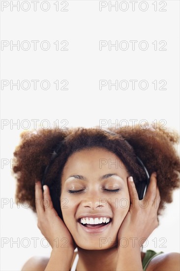 Woman listening to music. Photographer: momentimages