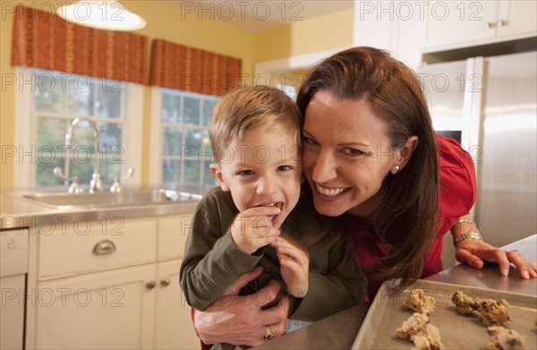 Mother and son baking cookies. Photographer: mark edward atkinson