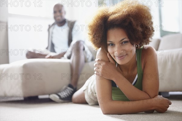 Couple relaxing in living room. Photographer: momentimages