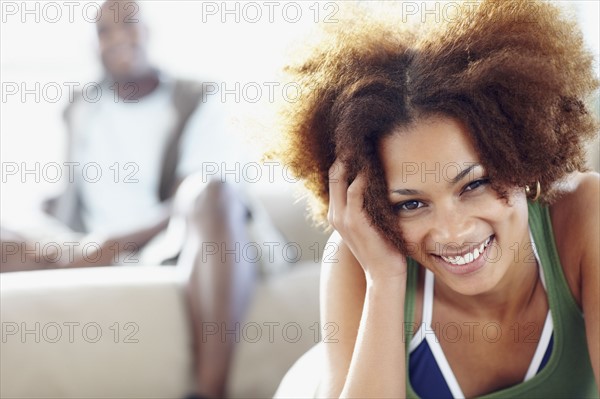 Couple relaxing in living room. Photographer: momentimages