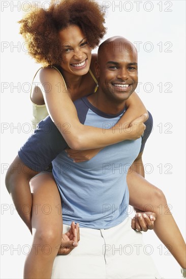 Man giving woman a piggy back ride. Photographer: momentimages