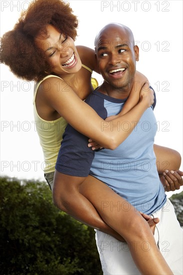 Man giving woman a piggy back ride. Photographer: momentimages