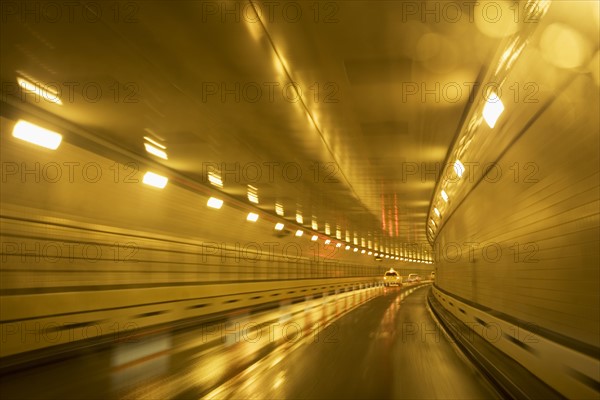 Cars driving in a tunnel. Photographer: fotog