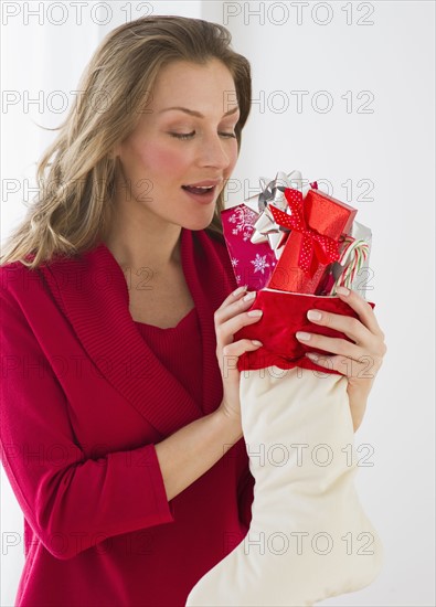 Woman holding Christmas stocking.