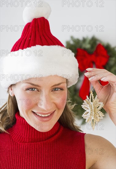 Woman holding Christmas decoration.