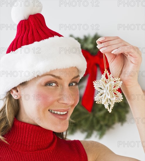 Woman holding Christmas decoration.