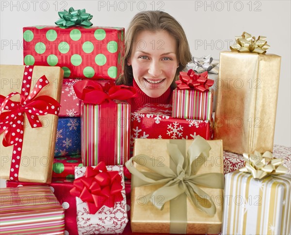 Woman behind Christmas presents.