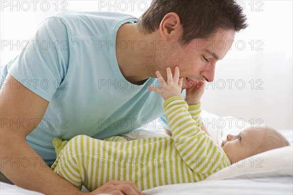 Father and baby playing.