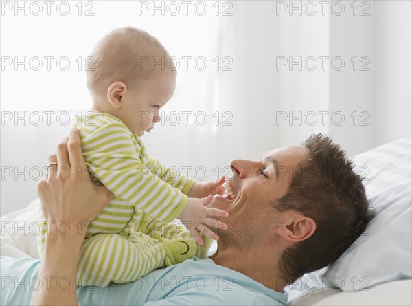 Father and baby playing.