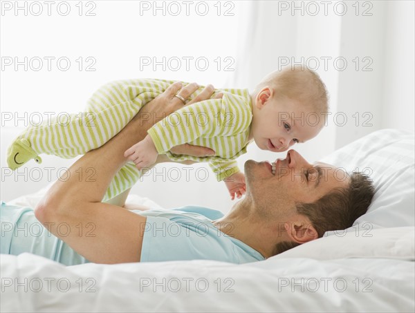 Father and baby playing.