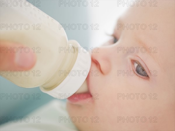 Baby drinking from bottle.