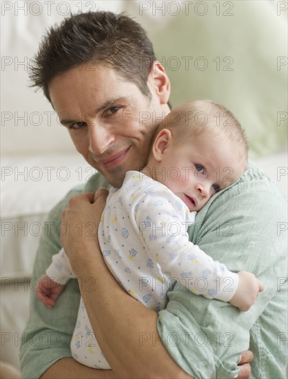 Father hugging baby.