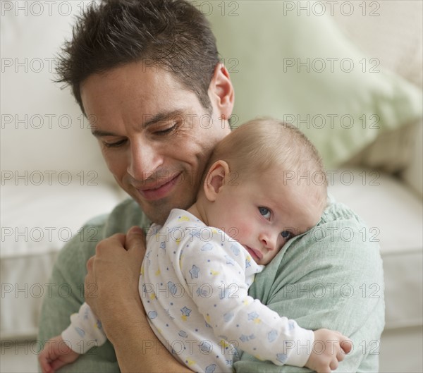 Father hugging baby.