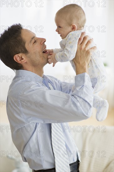 Businessman holding baby.