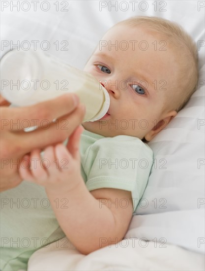 Baby drinking from bottle.