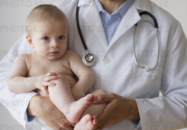 Doctor holding baby.