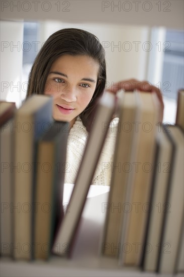 Student selecting book.