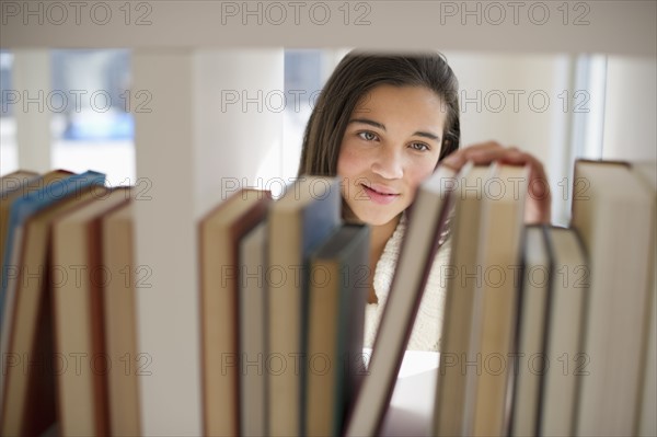 Student selecting book.